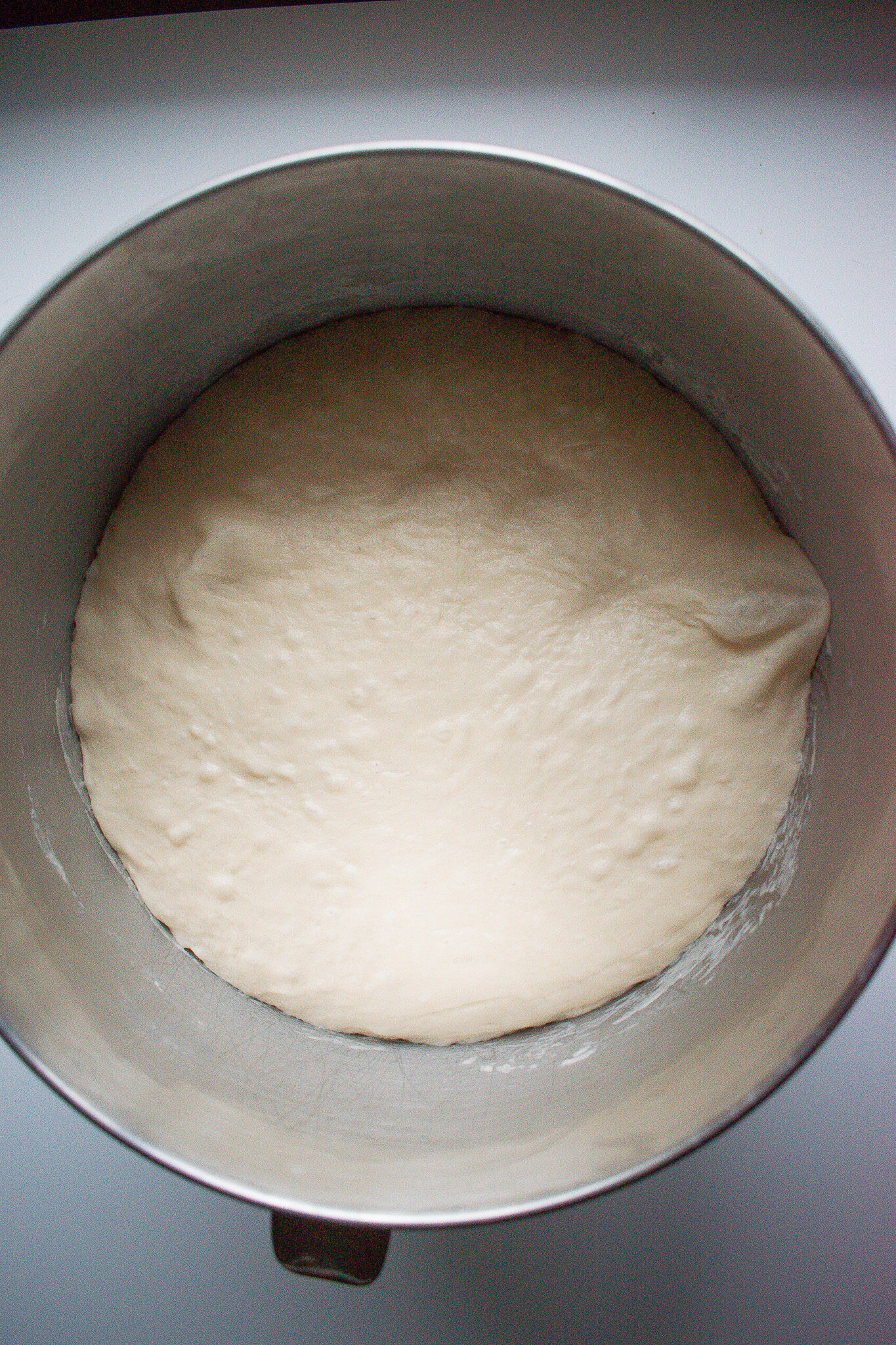 Overnight sourdough sandwich bread in a mixing bowl after proofing.