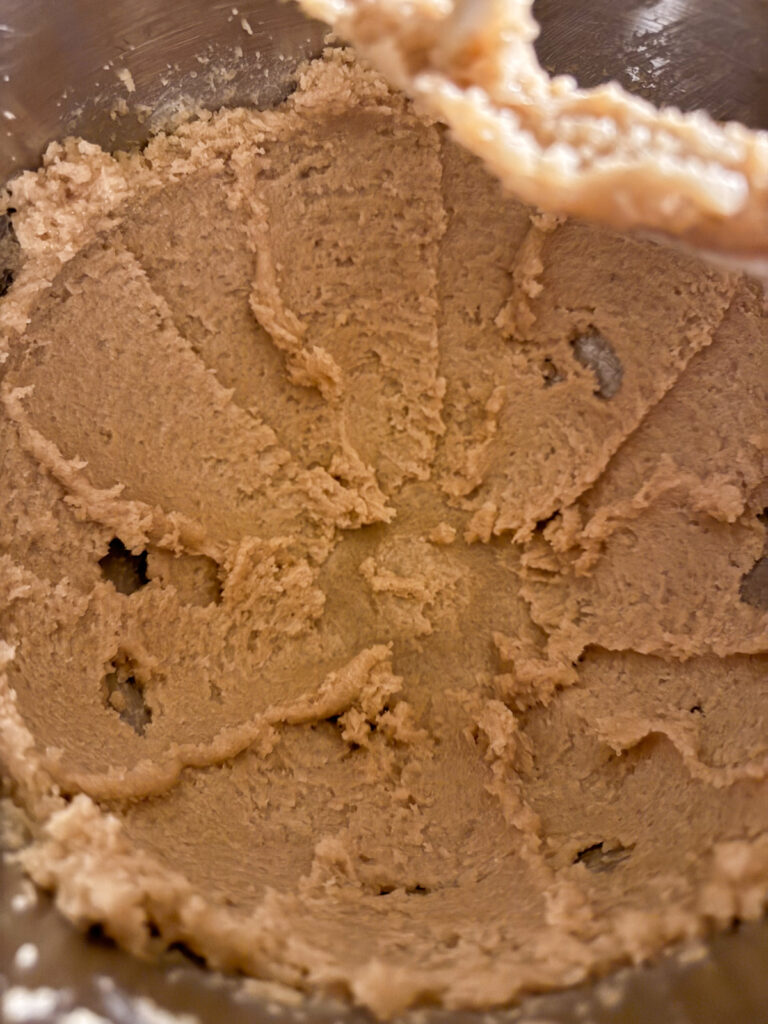 Beaten butter and sugar in a mixing bowl for sourdough discard chocolate peanut butter cookies.