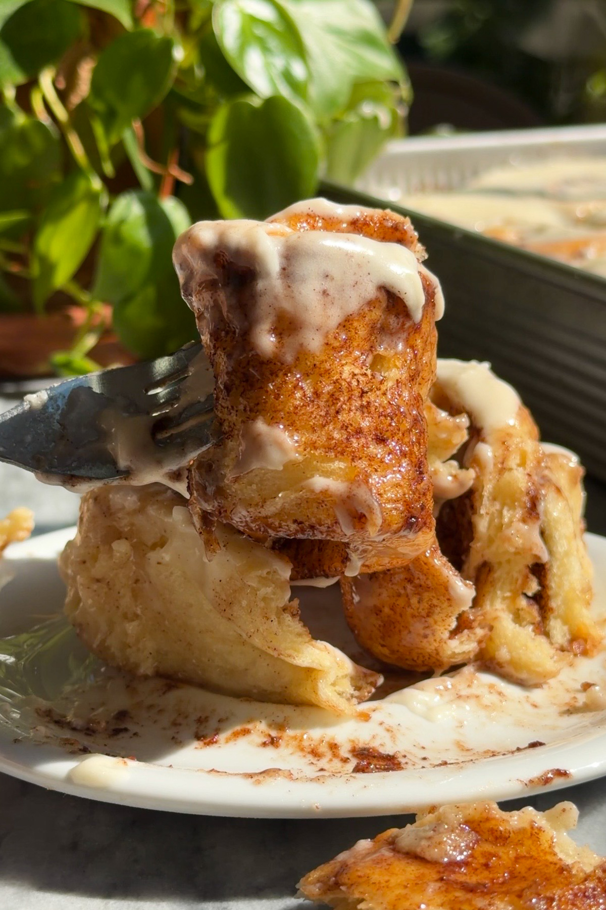 Picture of sourdough discard cinnamon rolls on a fork to show gooey layers.