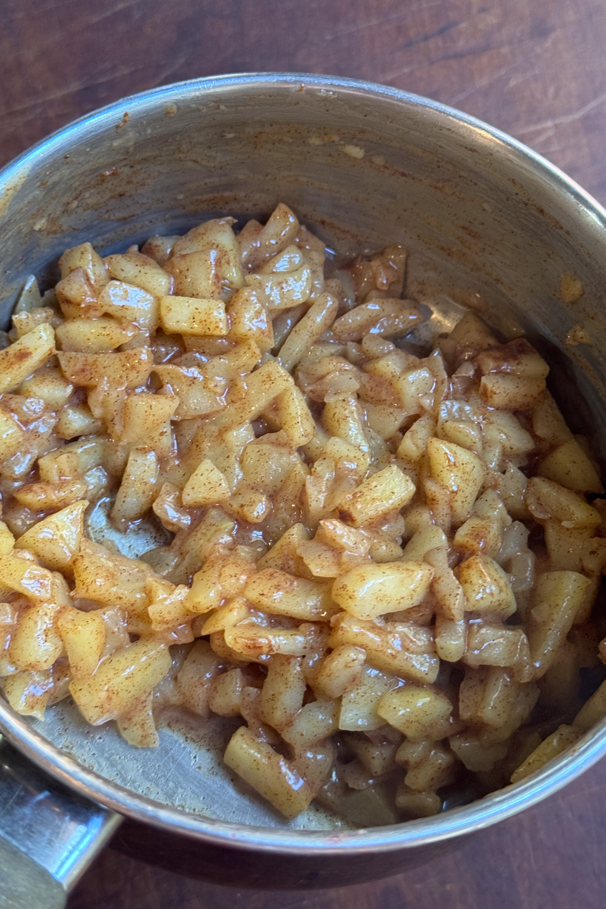 Picture of apple pie filling in a small sauce pan for apple pie cinnamon rolls.