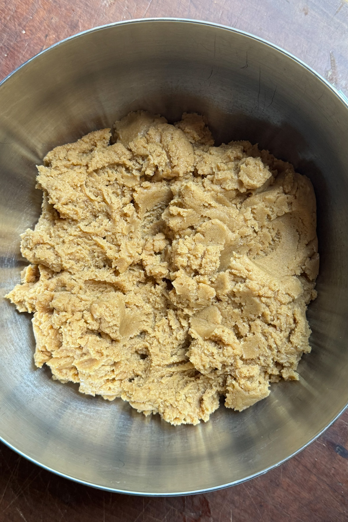 Picture of brown butter snickerdoodle cookie dough in a stainless steel bowl. 