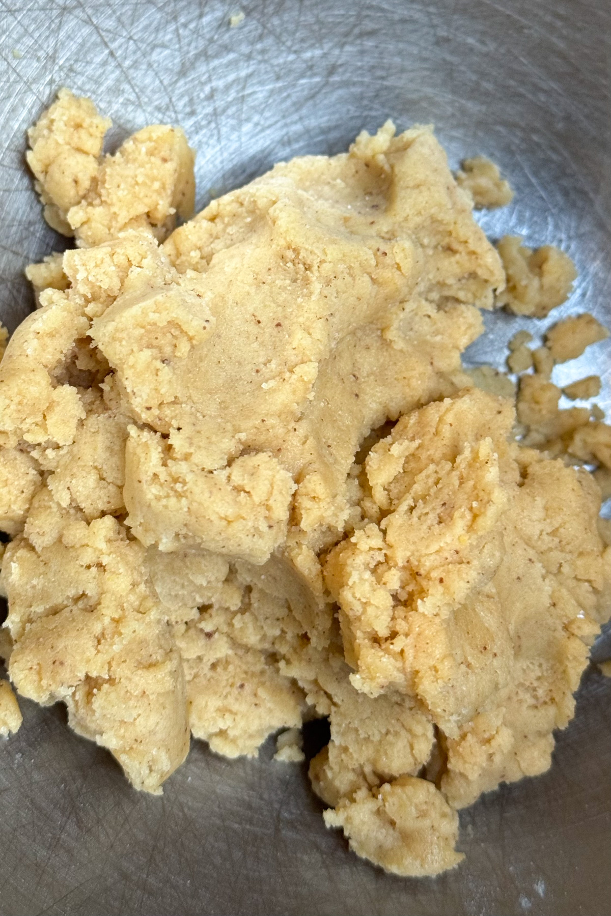 Picture of brown butter sugar cookie dough in a stainless steel bowl.