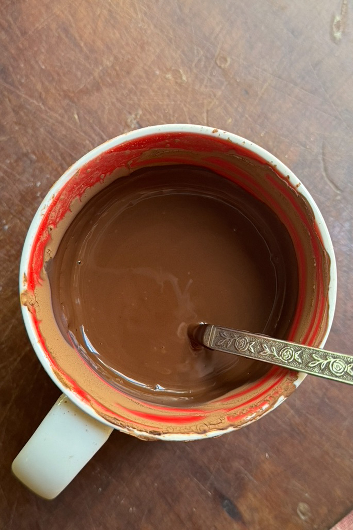 Overhead picture of cocoa powder dissolved in hot water for a chocolate sour cream pound cake.