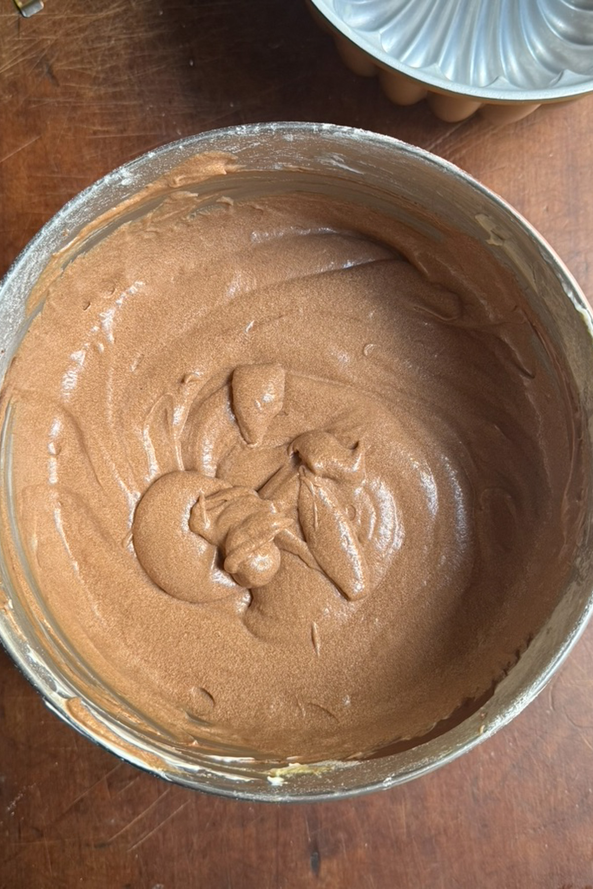 Overhead picture of the batter for chocolate sour cream pound cake in a metal bowl.