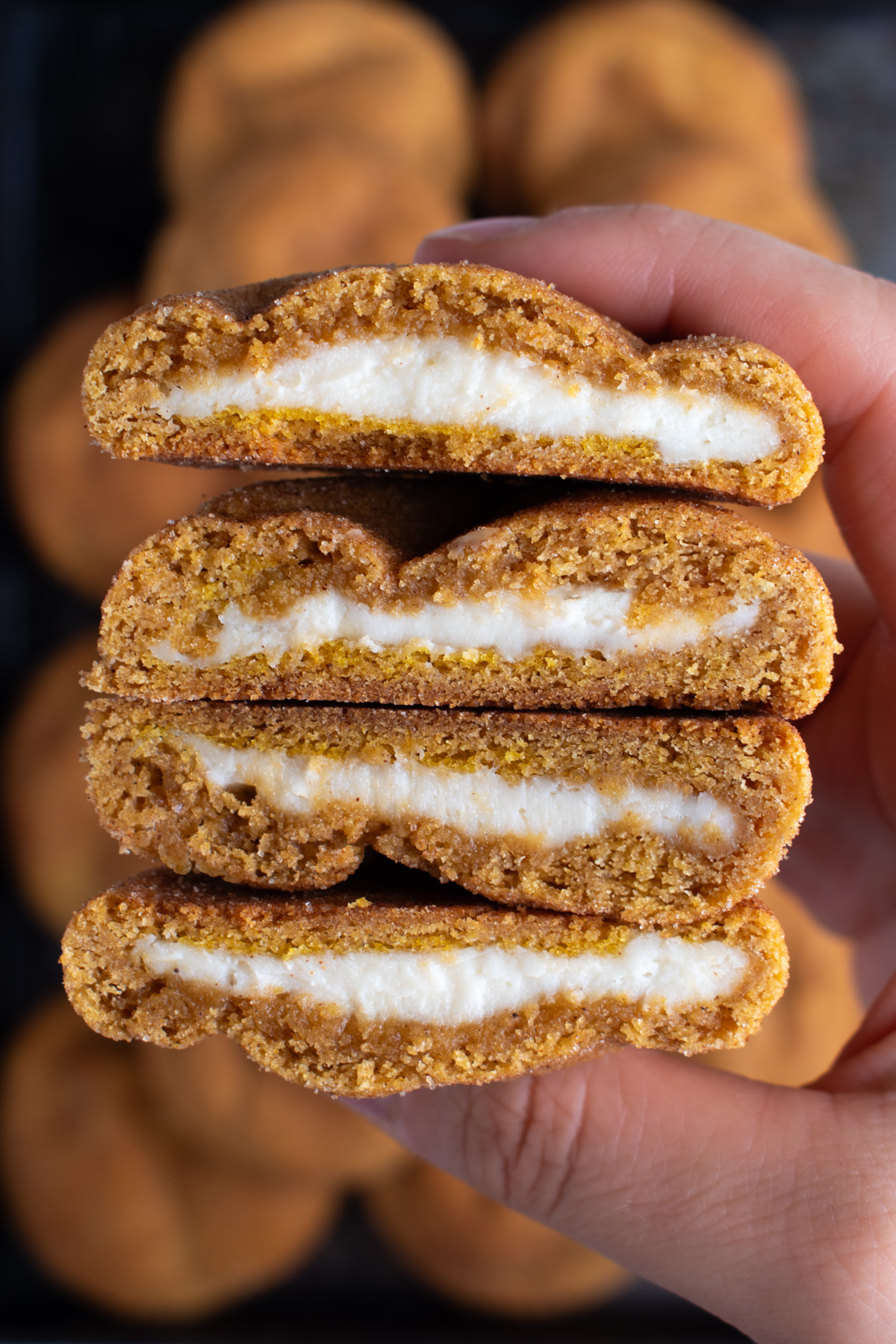 Picture of pumpkin cheesecake cookies stacked on each other.