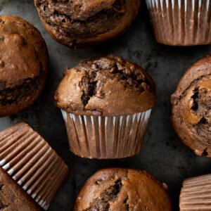Picture of sourdough chocolate banana muffins on a metal baking sheet.