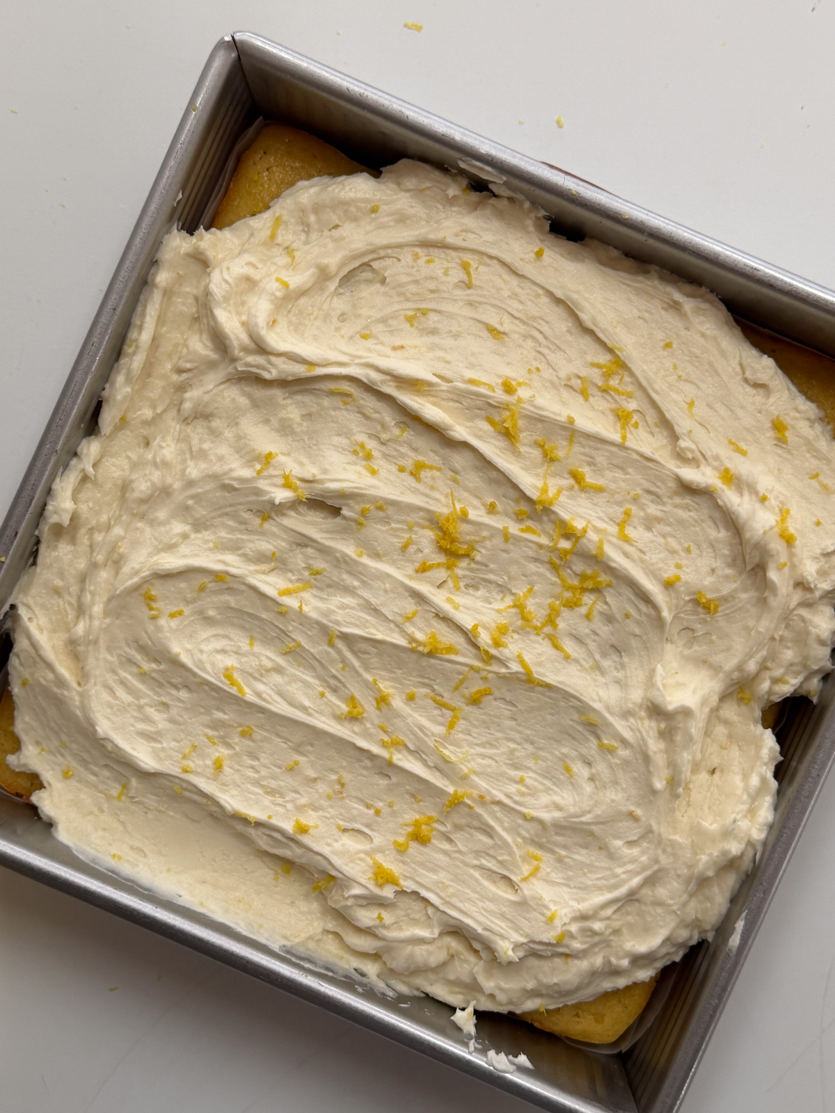 Overhead picture of sourdough discard lemon snack cake with lemon buttercream frosting. 