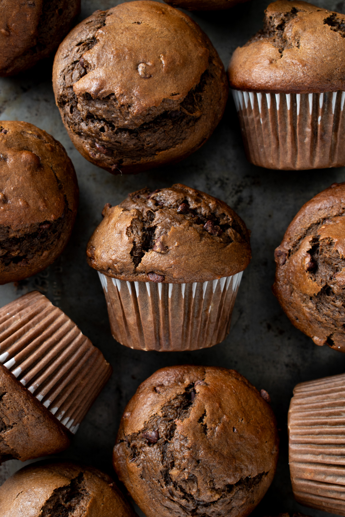 Overhead image of sourdough discard chocolate banana muffins on a metal tray. 