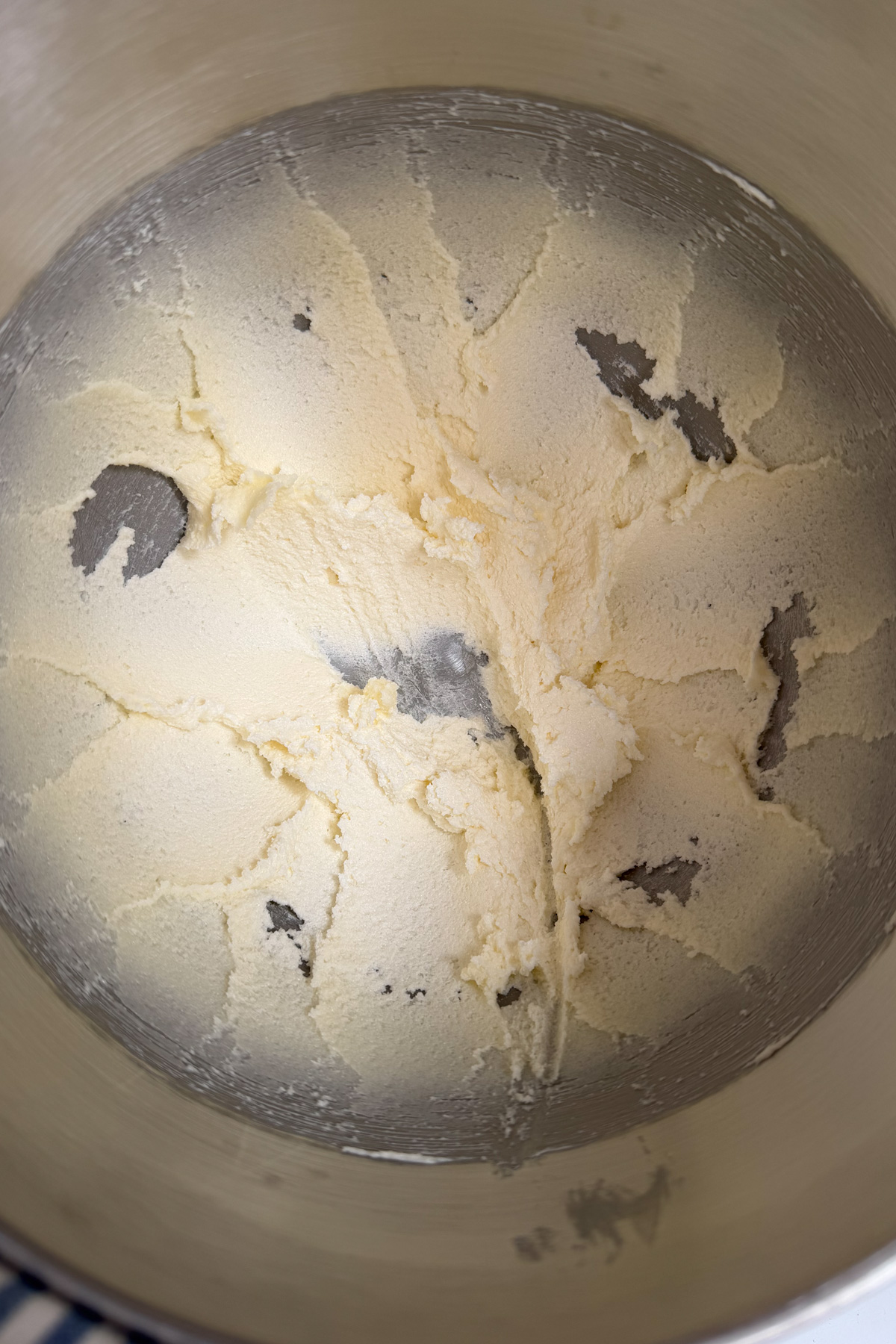 Picture of creamed butter and sugar for a sourdough lemon pound cake in a steel mixing bowl.