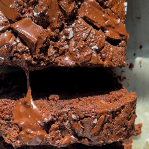 Overhead picture of chocolate chunk banana bread cut into slices with melted chocolate stretching between slices.