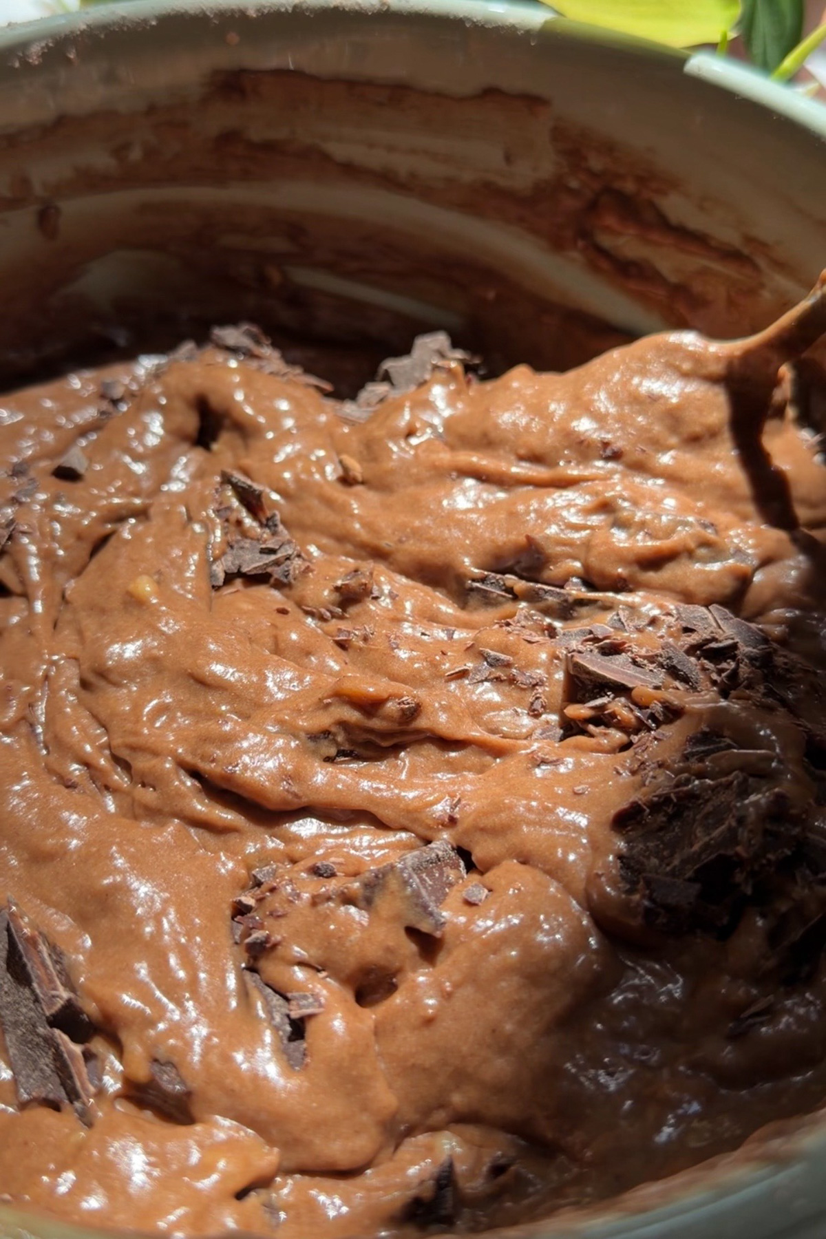 Picture of step 1 of the instructions for making chocolate-chunk banana bread, mixing in the dry ingredients and chopped chocolate.