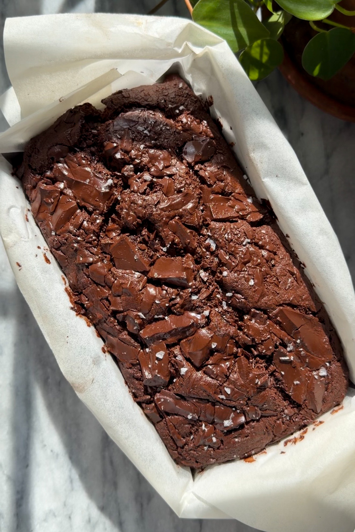 Picture of step 1 of the instructions for making chocolate-chunk banana bread, baking and cooling the banana bread.