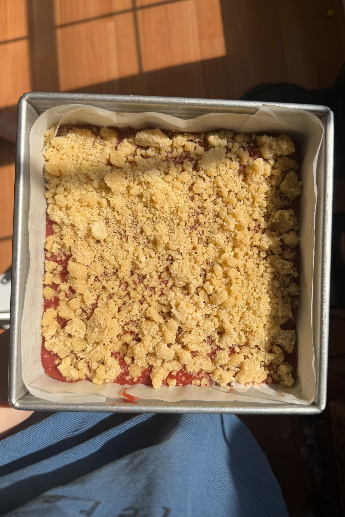 Step 3 of the instructions for strawberry rhubarb crumb bars. Assemble the crumb bars. 