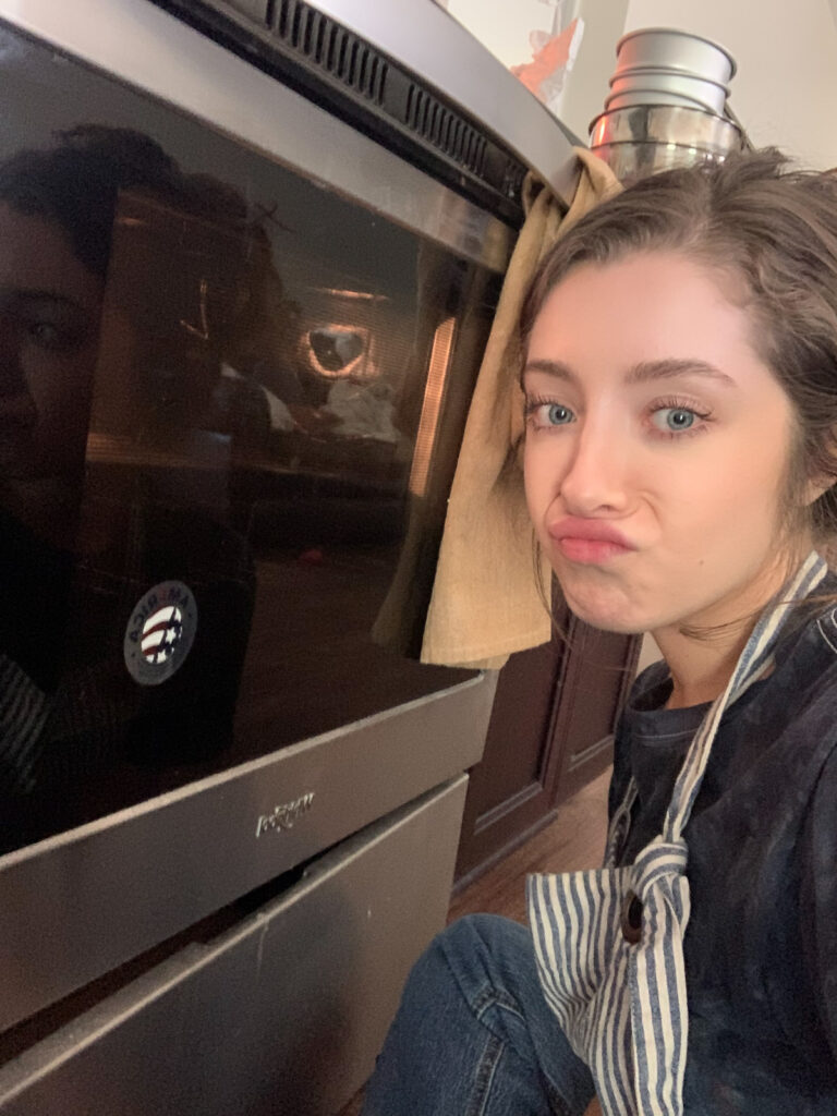 Kneaded that owner, sitting in front of a cooking oven.