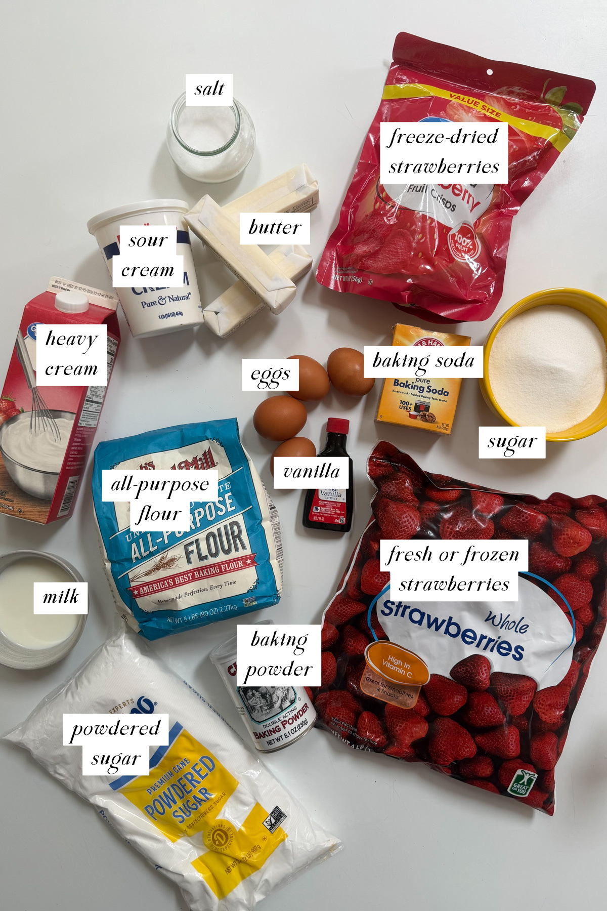 Ingredients needed for a strawberry cake with strawberry filling with labels.