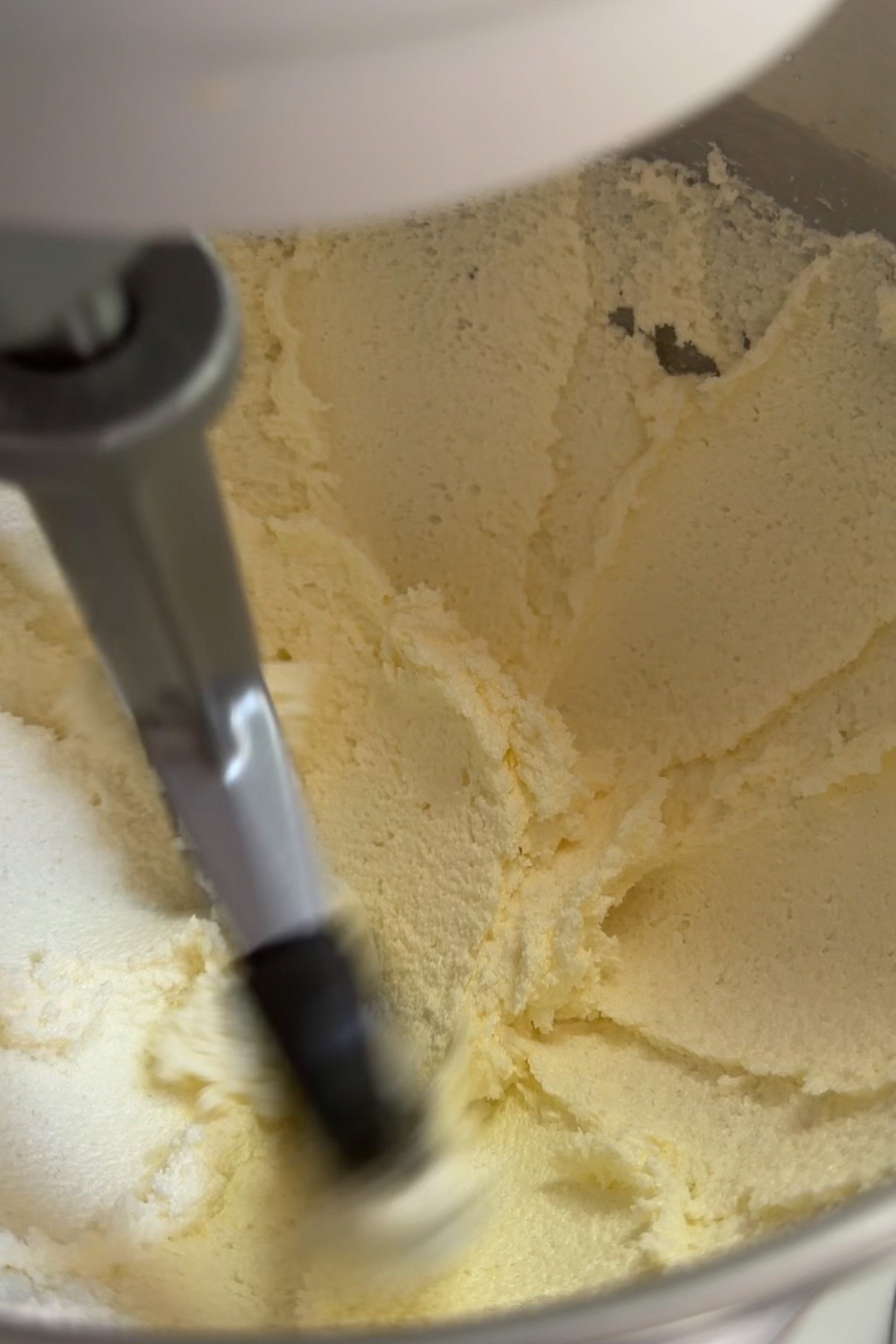 Creamed butter and sugar for the batter for strawberry cake with strawberry filling.