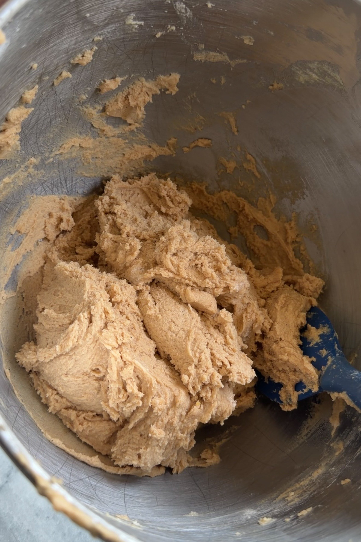 Cookie dough for apple butter snickerdoodle cookies in a stainless steel mixing bowl.