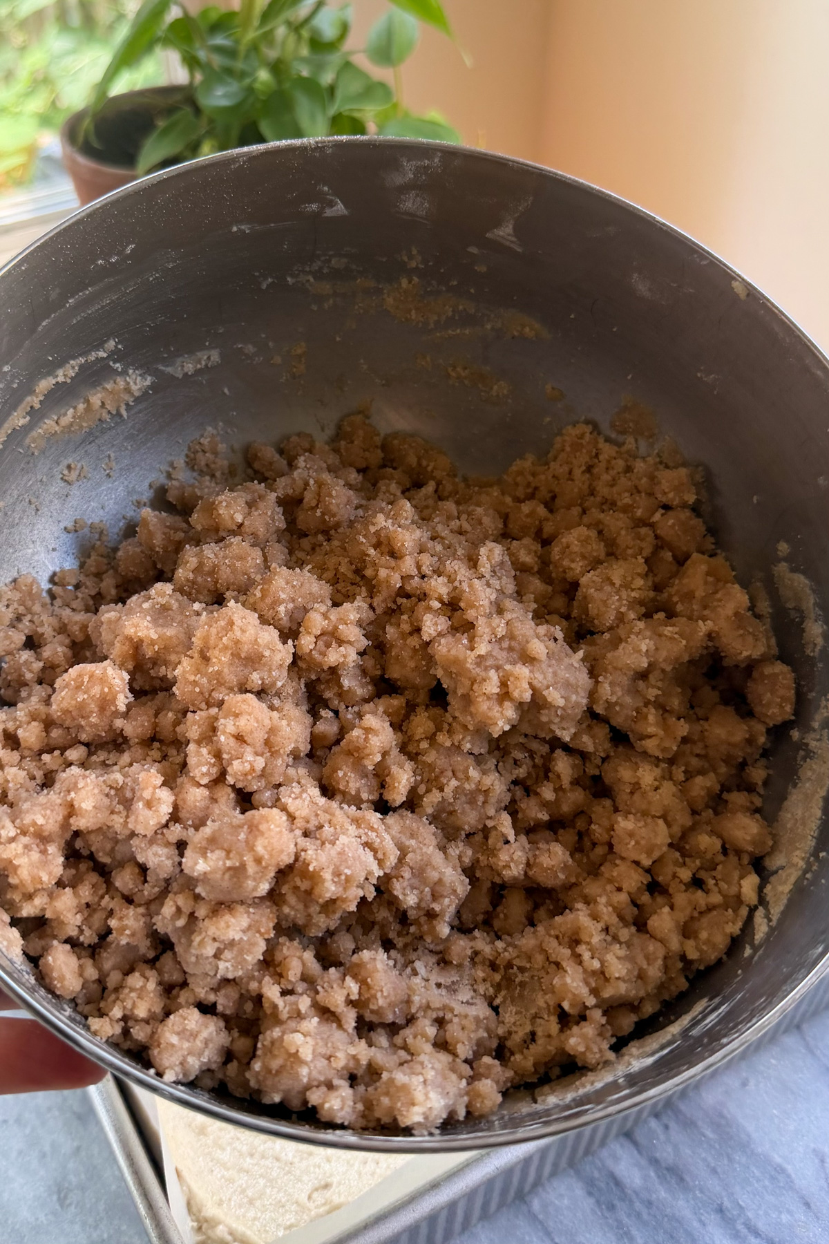 Streusel topping in a stainless steel mixing bowl for New York-Style Applesauce Crumb Cake.