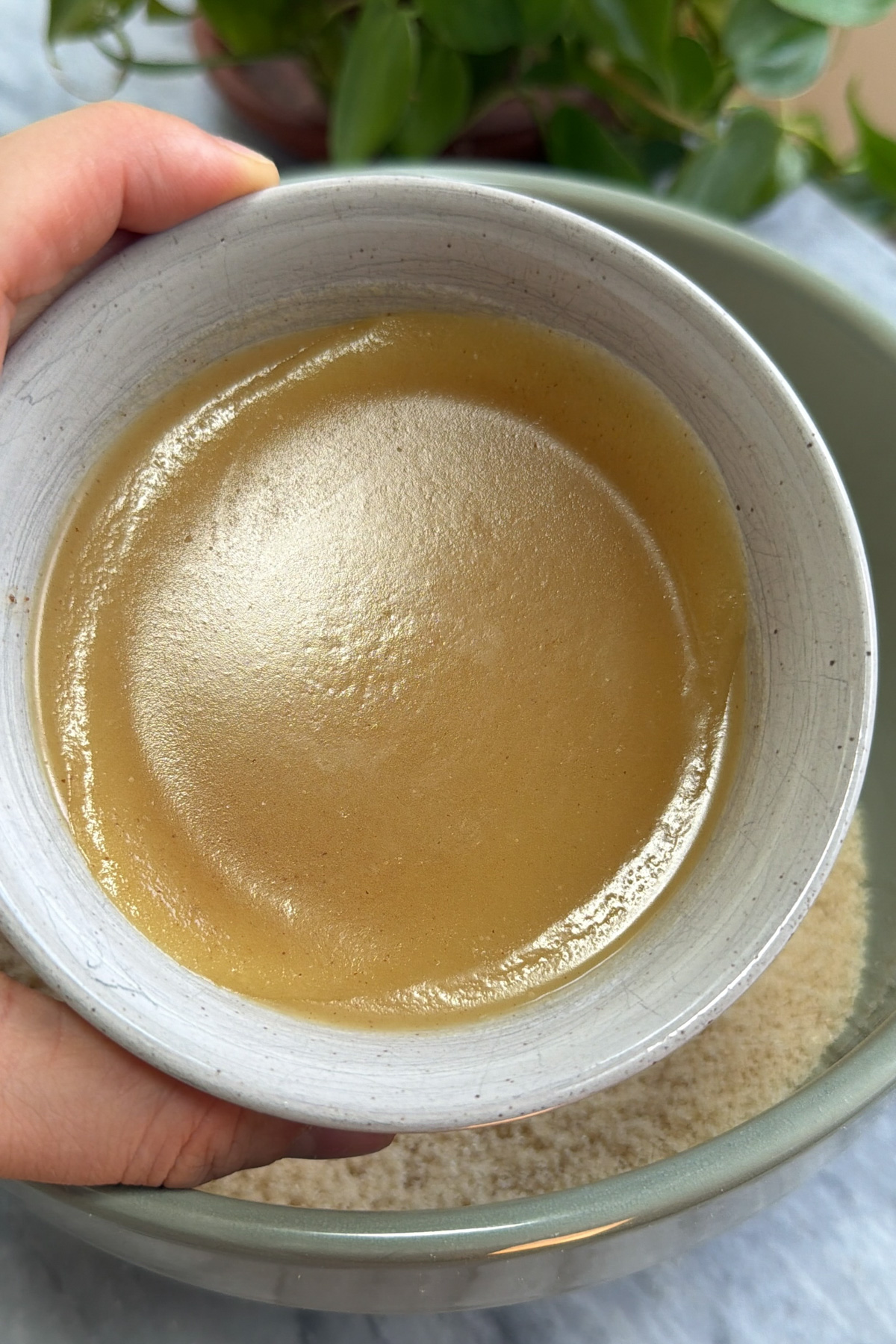 Cooled brown butter in a small bowl to be added to brown butter peach coffee cake.