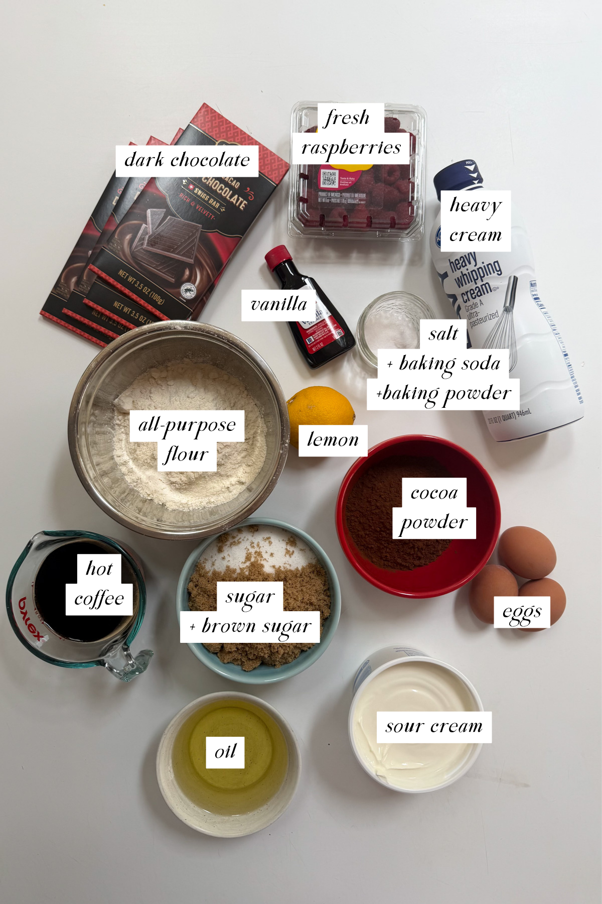 The ingredients needed for a dark chocolate raspberry layer cake with labels.