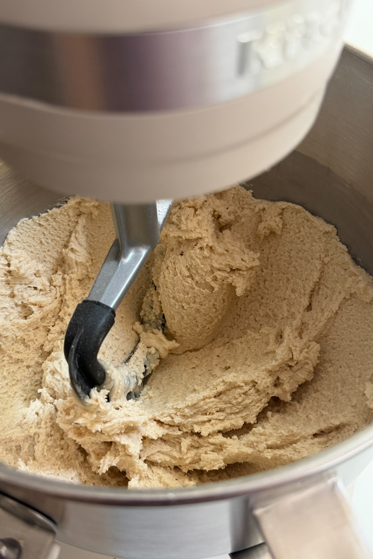 Butter being reverse creamed in a stand mixer for brown butter peaches and cream cake.
