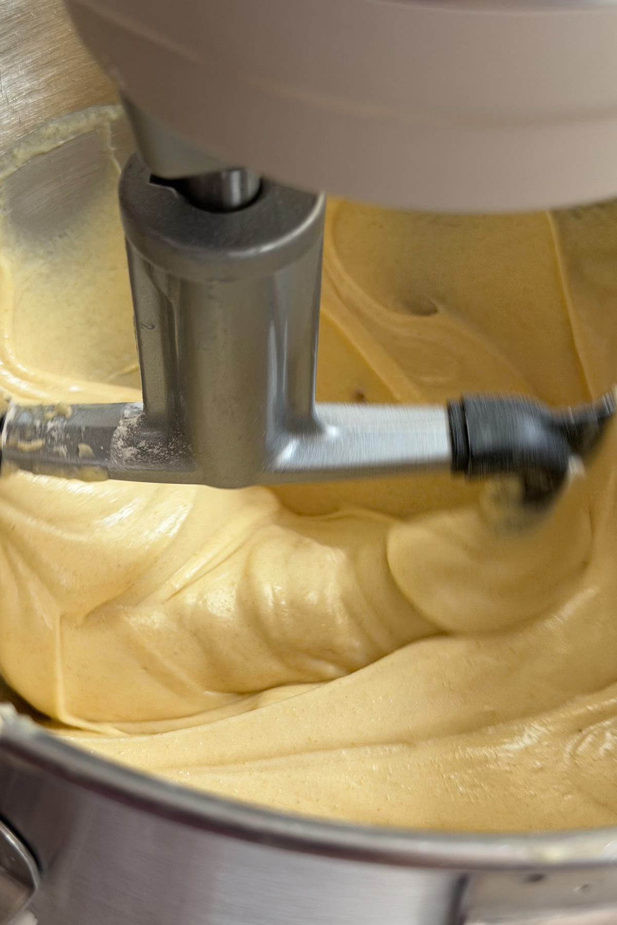 Brown butter cake batter in a stand mixer for brown butter bourbon peaches and cream cake.