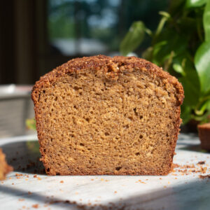 Apple butter banana bread sliced on a marble countertop to show a soft, tight crumb.
