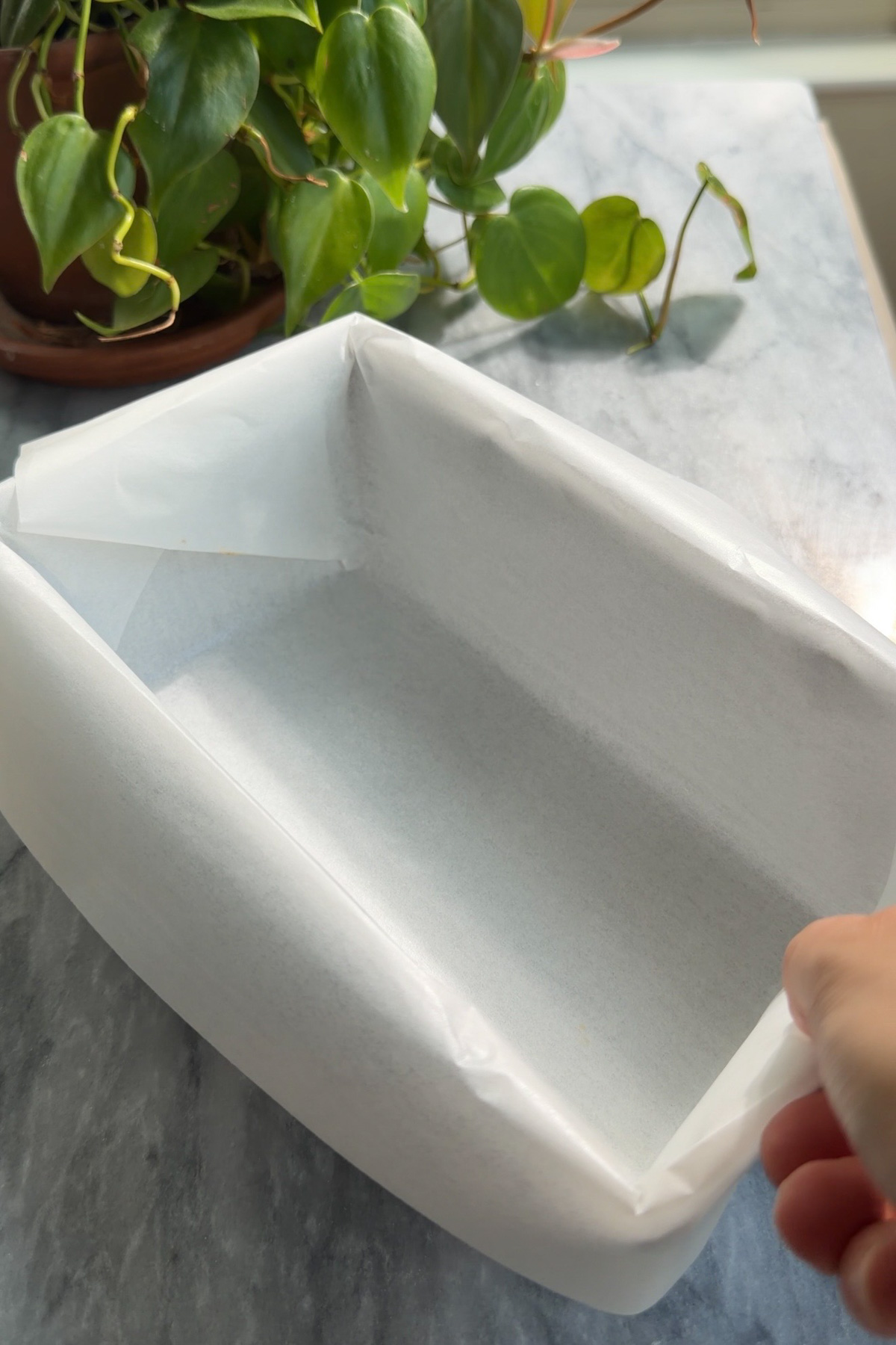 A lined 9x5 inch loaf pan for pumpkin bread.