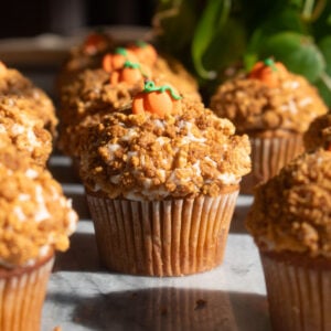Pumpkin crunch cupcakes coated in Golden Oreo crumble and topped with pumpkin decorations