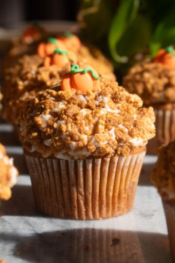 Pumpkin crunch cupcakes coated in Golden Oreo crumble and topped with pumpkin decorations